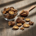 Badhari Qand (Bhadra Kand/Wild Yam Root) dried root pieces on wooden surface with glass bowl and wooden spoon