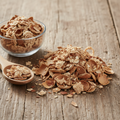 Almond Straw dried husks and shells (Tikh-e-Badam) on wooden surface with glass bowl and wooden spoon