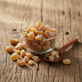 Indian Frankincense Gum resin (Kundur/Loban) on wooden surface with glass bowl and wooden spoon