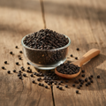 Chaksu Seeds (Tukhm-e-Chaksu/Cassia Absus) small hard dark brown-black seeds on wooden surface with glass bowl and wooden spoon