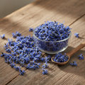 Borage Flower (Gul Gao Zaban/Borago Officinalis) vibrant dried blue star-shaped blossoms on wooden surface with glass bowl and wooden spoon